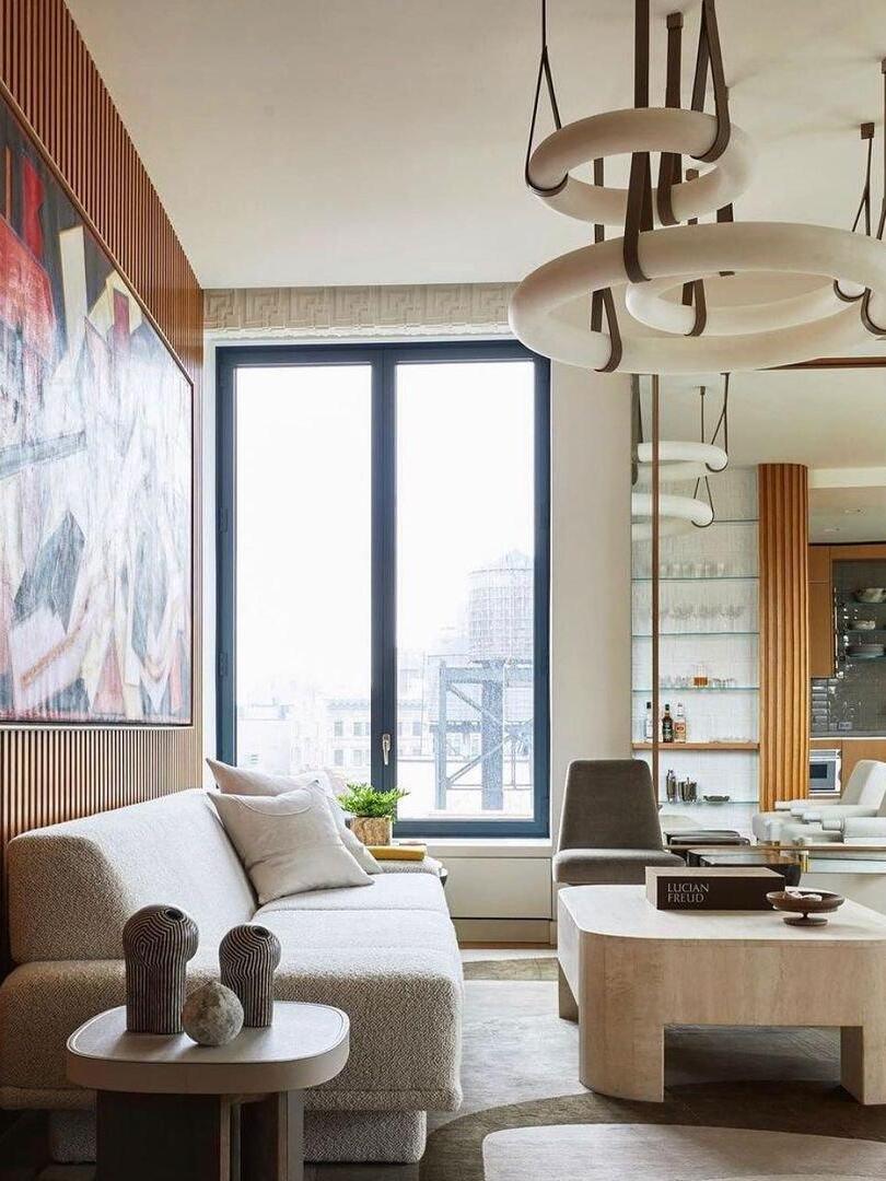 Ring pendants near a tall window and sofa