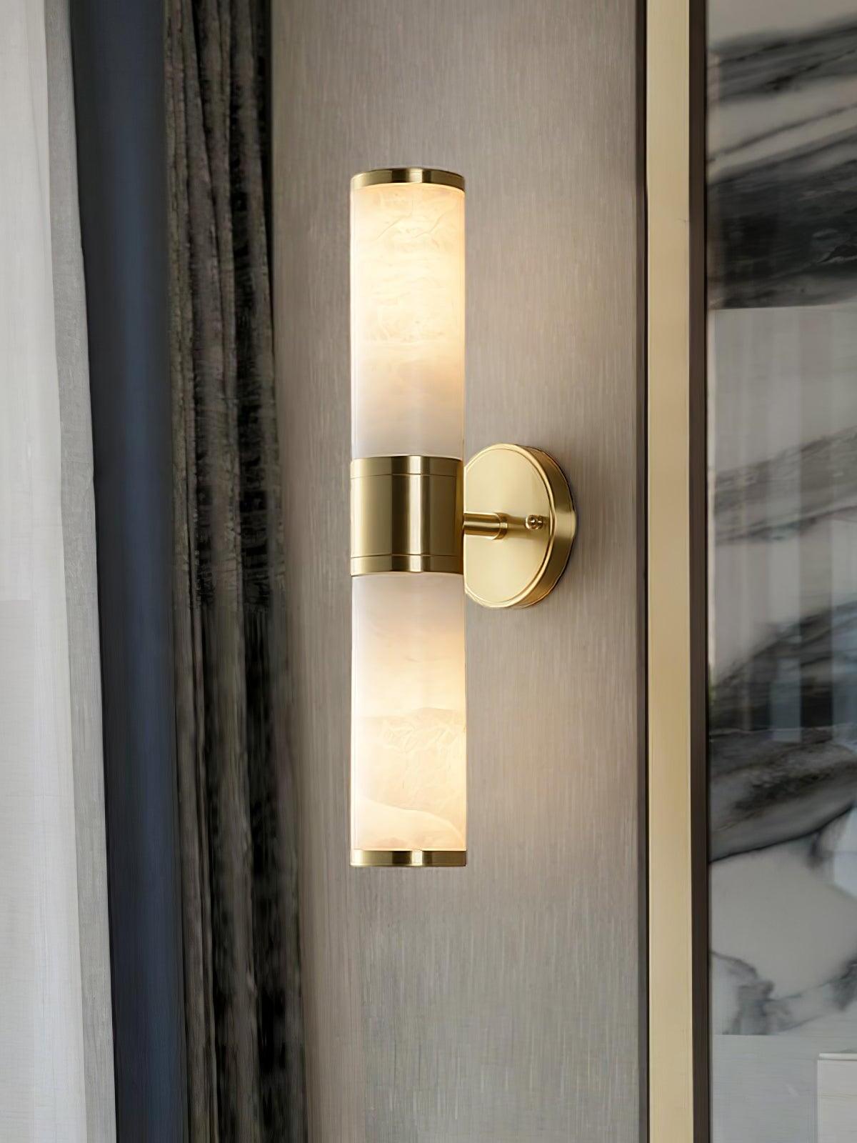 Double-ended alabaster wall sconce on dark wall