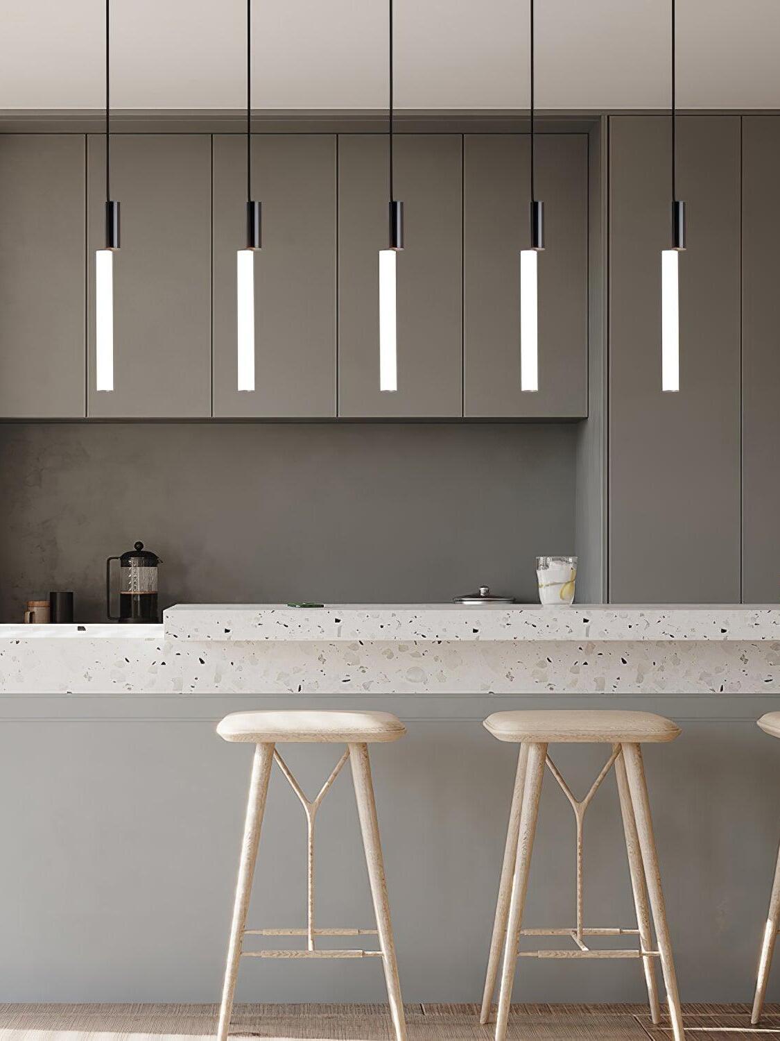 Five black-top tube pendants above kitchen counter