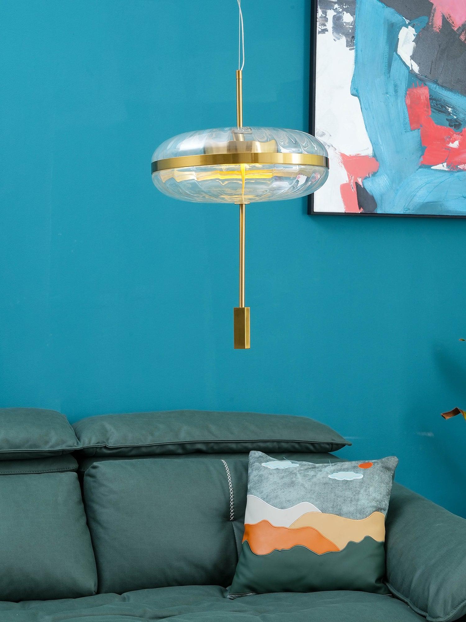 Glass pendant above a sofa in a blue room
