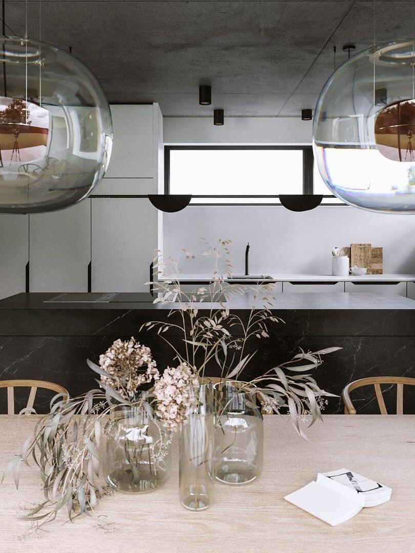 Glass pendants above a pale dining table with flowers