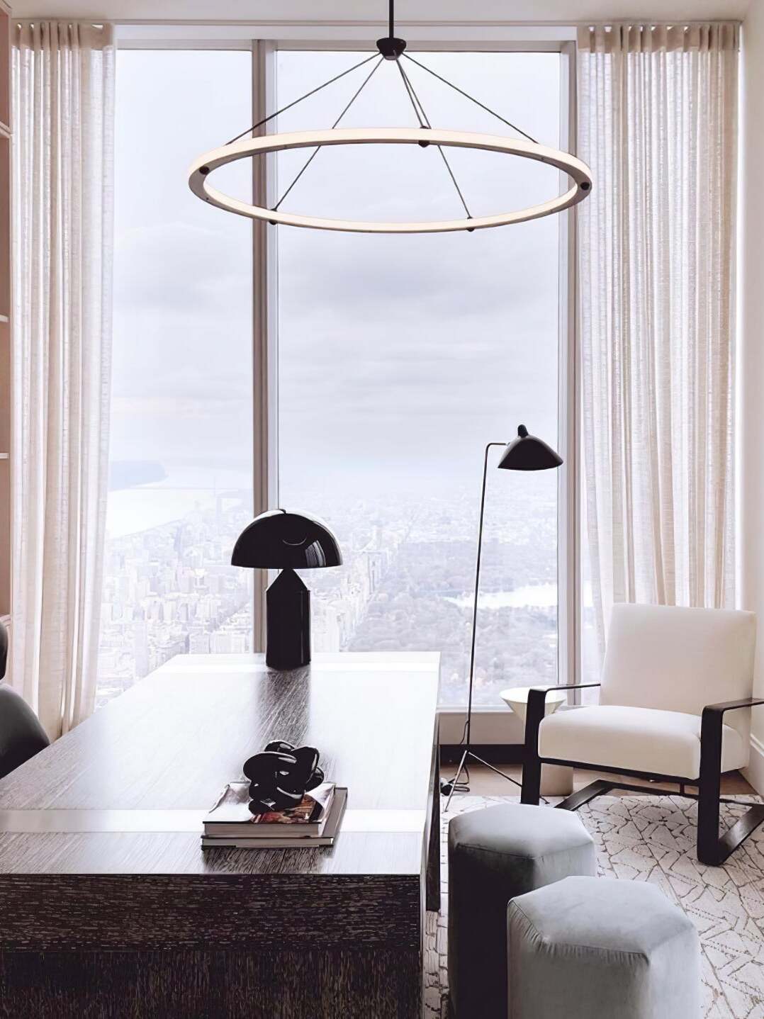 Black single ring pendant above low sitting-room table