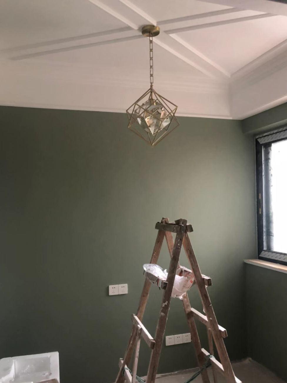 Epic pendant suspended from a paneled ceiling in a green room above a wooden ladder