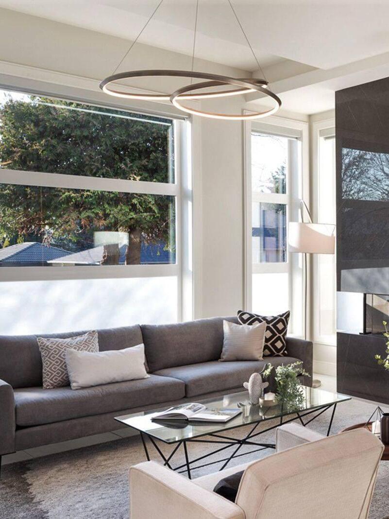 Pale loop chandelier above a sofa and coffee table