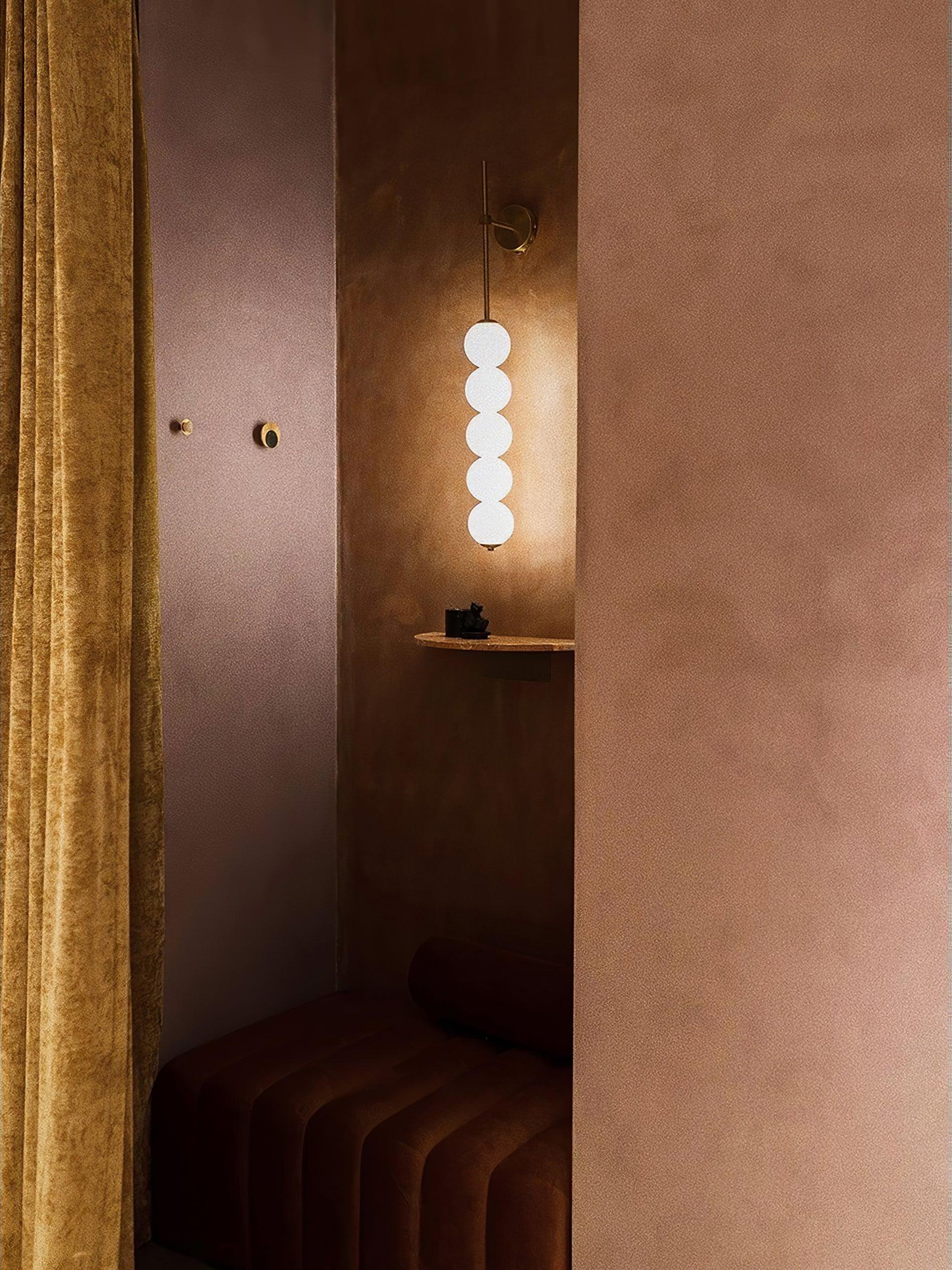 Globe wall lamp in a warm-toned alcove