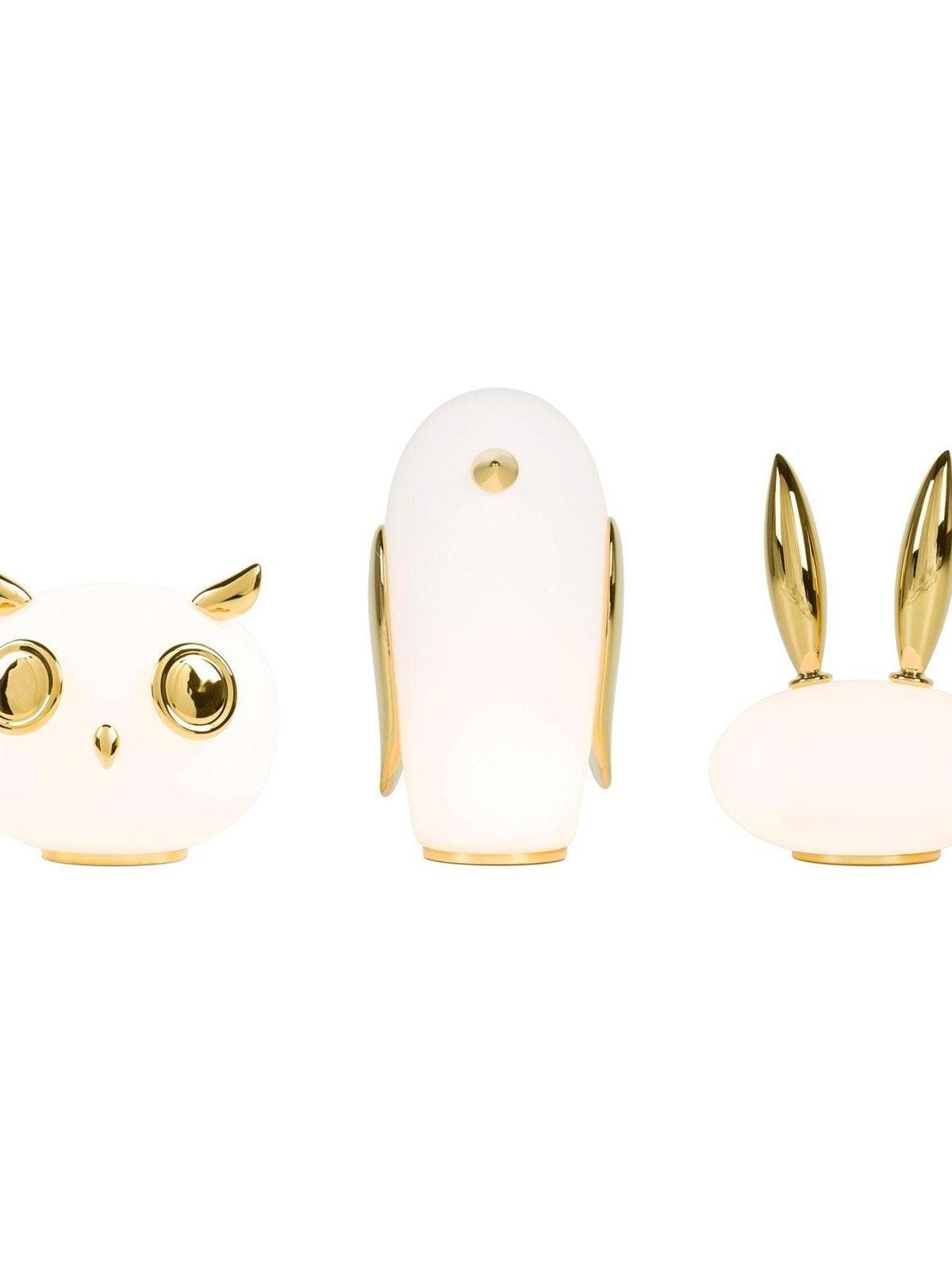 Isolated family group with owl at left, penguin centre and rabbit at right