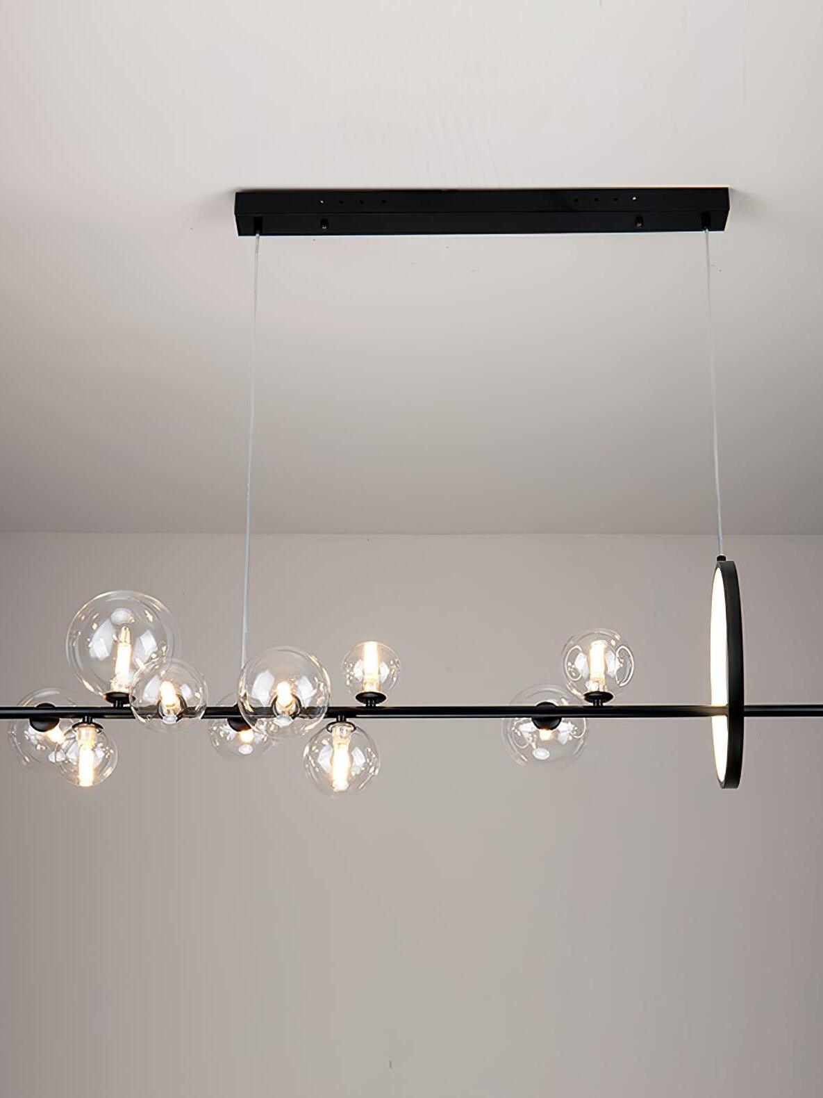 Linear frame, globes and vertical ring against a pale wall