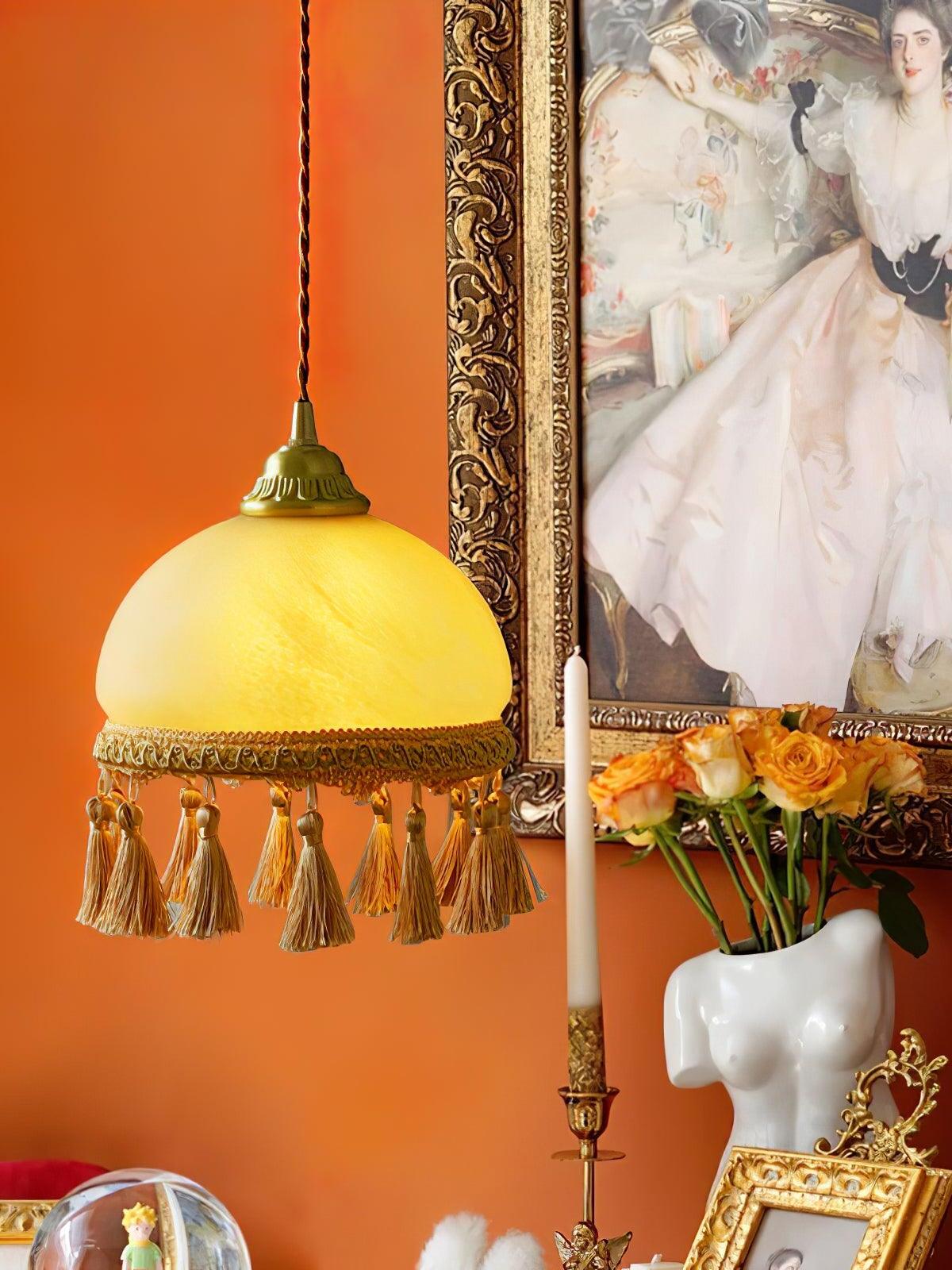 Pendant against orange wall and framed painting