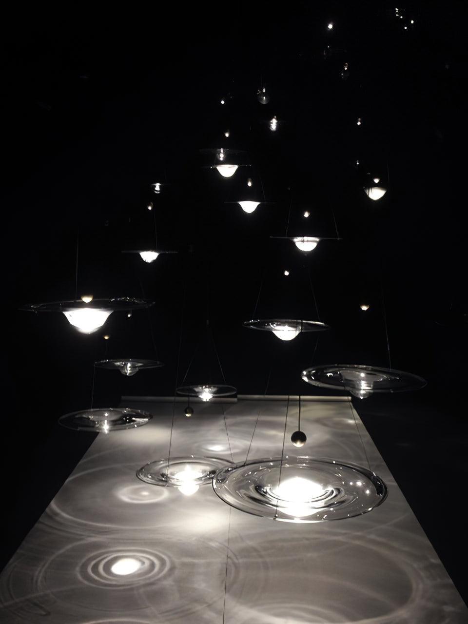 Glass disc pendants with concentric light patterns