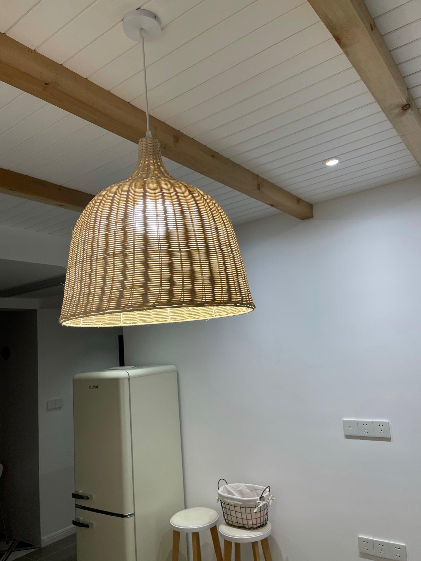 Rattan pendant beneath wooden ceiling beams