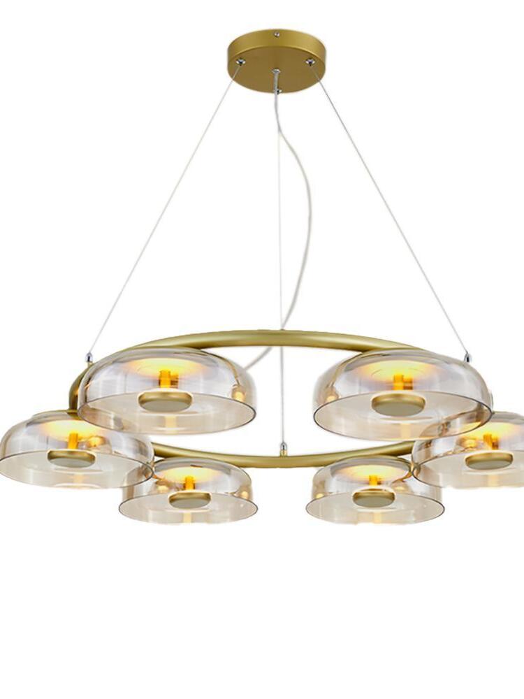 Gold ceiling canopy, suspension wires and clear glass shades of Blossi