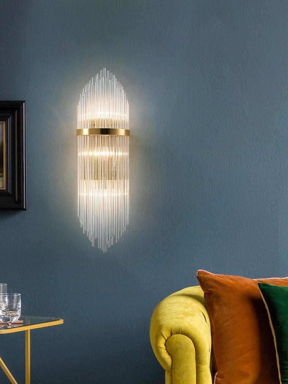 Crystal rod wall light above yellow chair against blue wall