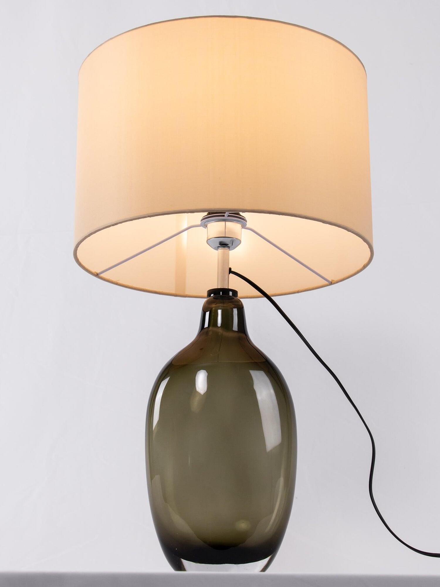 Underside of drum shade with metal supports above smoky base
