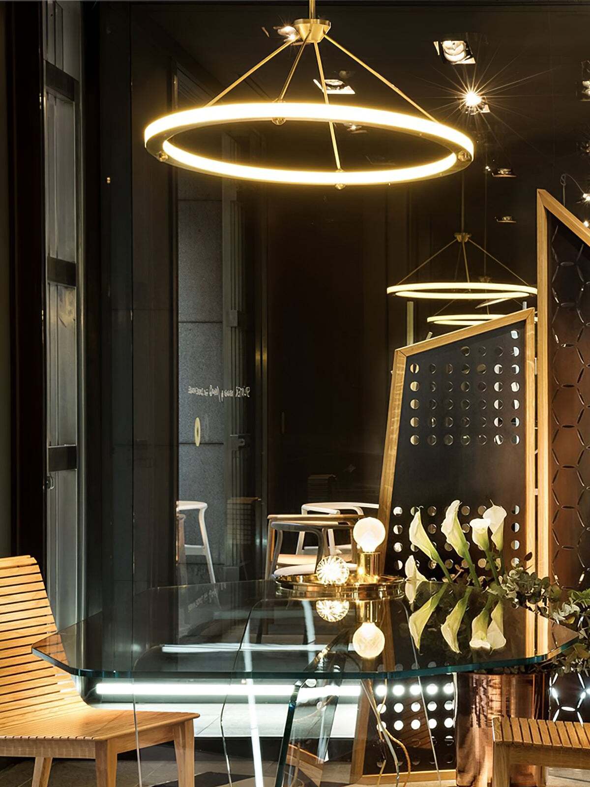 Glowing gold ring pendant in a dark dining interior