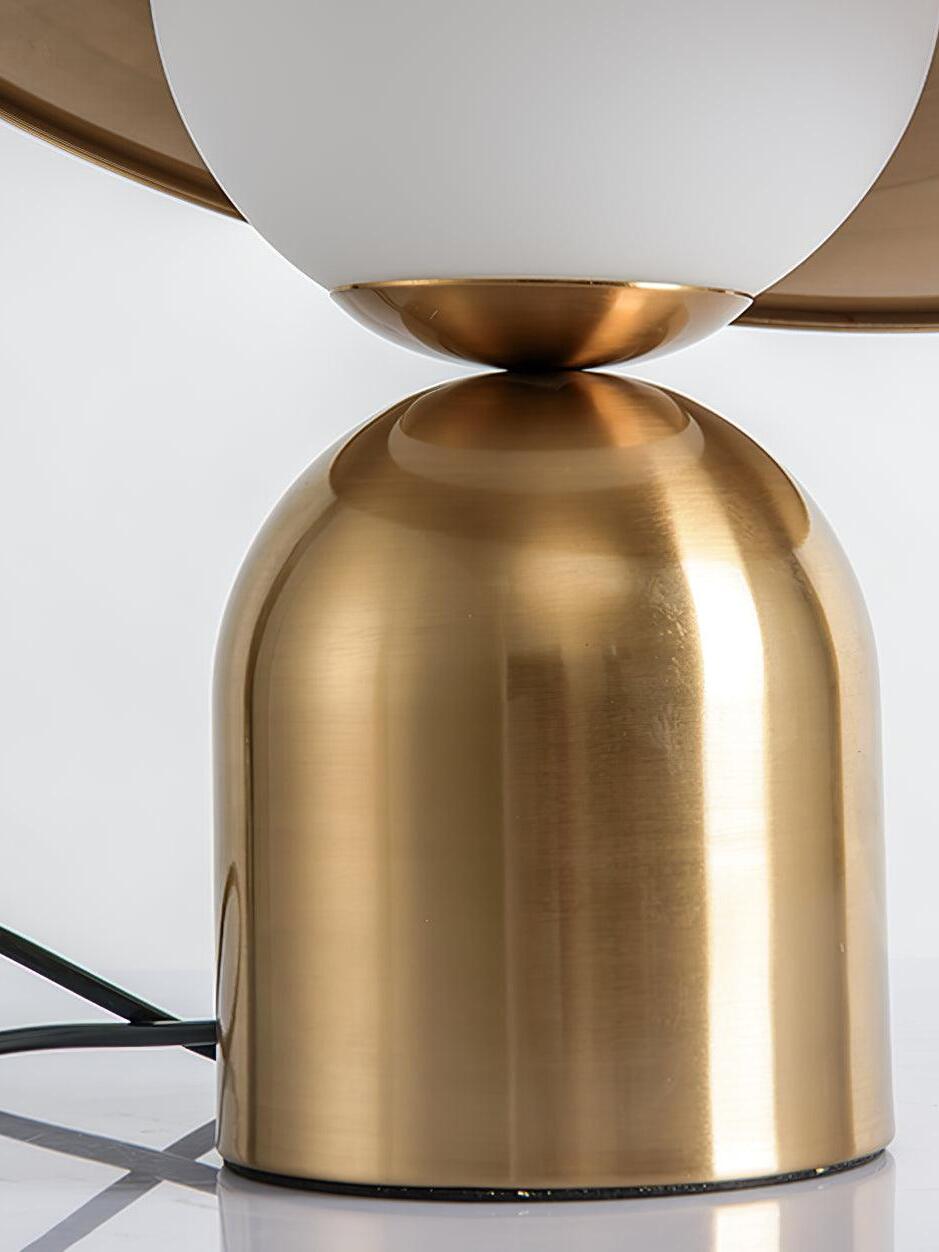 Close white globe above rounded gold lamp base