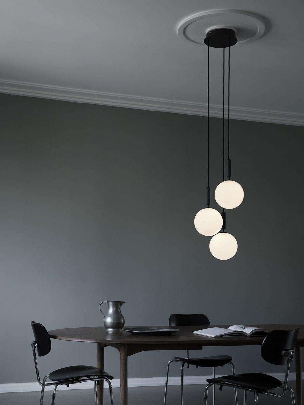 Three white globes suspended below a round canopy