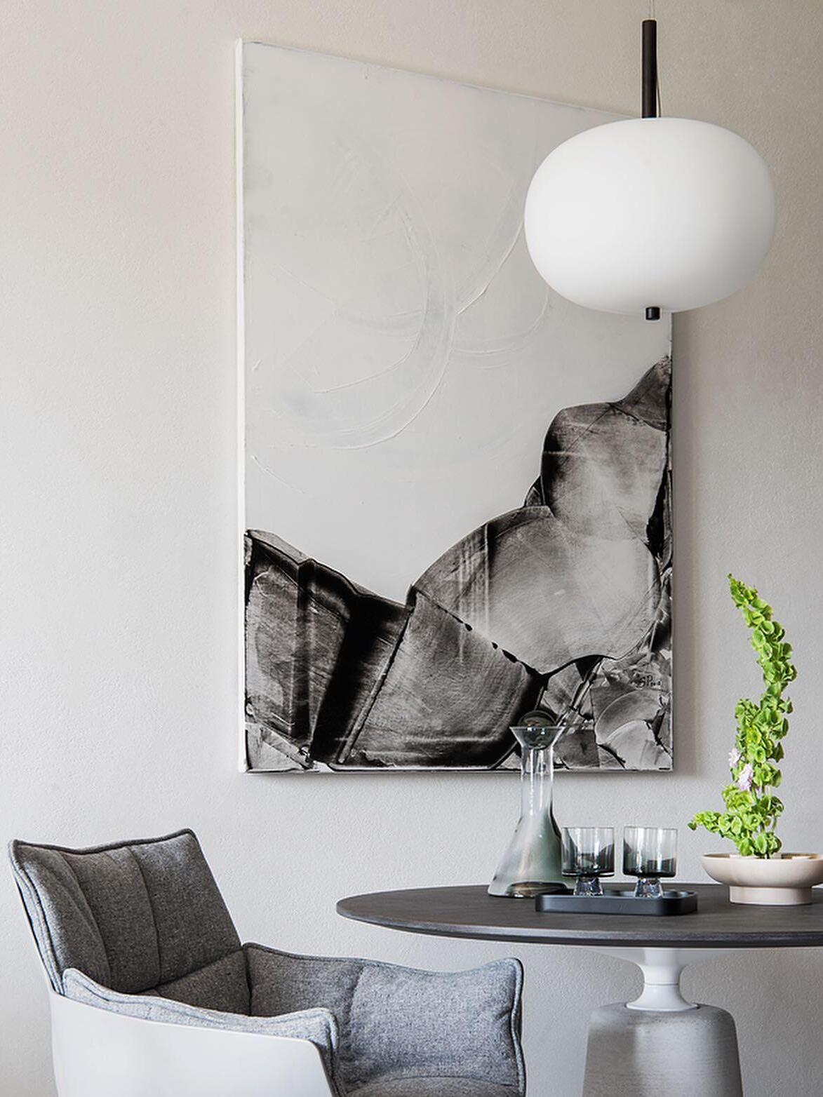 Single globe above a round dining table and chairs