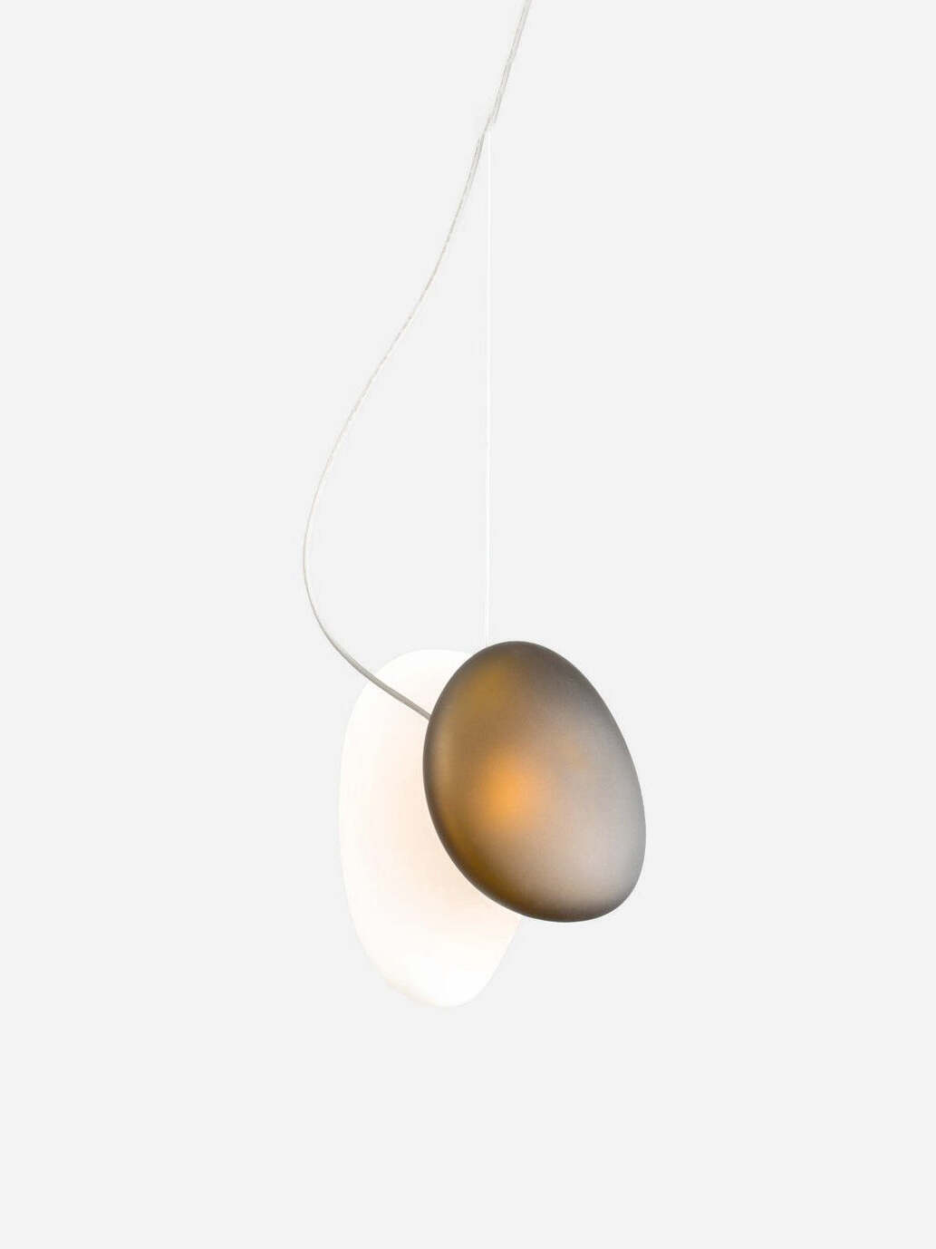 Close view of overlapping smoky and white pebble pendant forms
