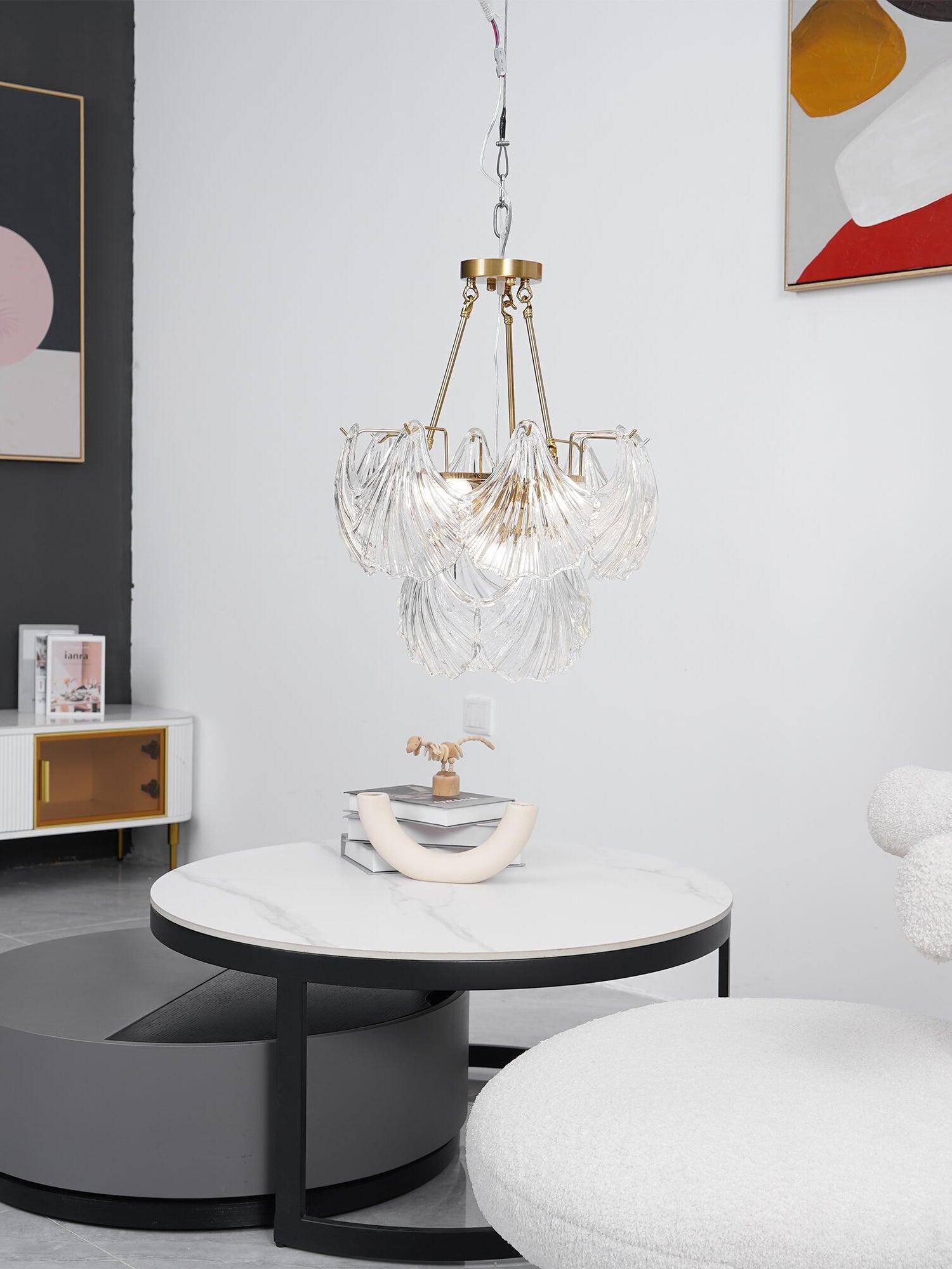 Wider room view of the glass light above a round table beside red and yellow artwork