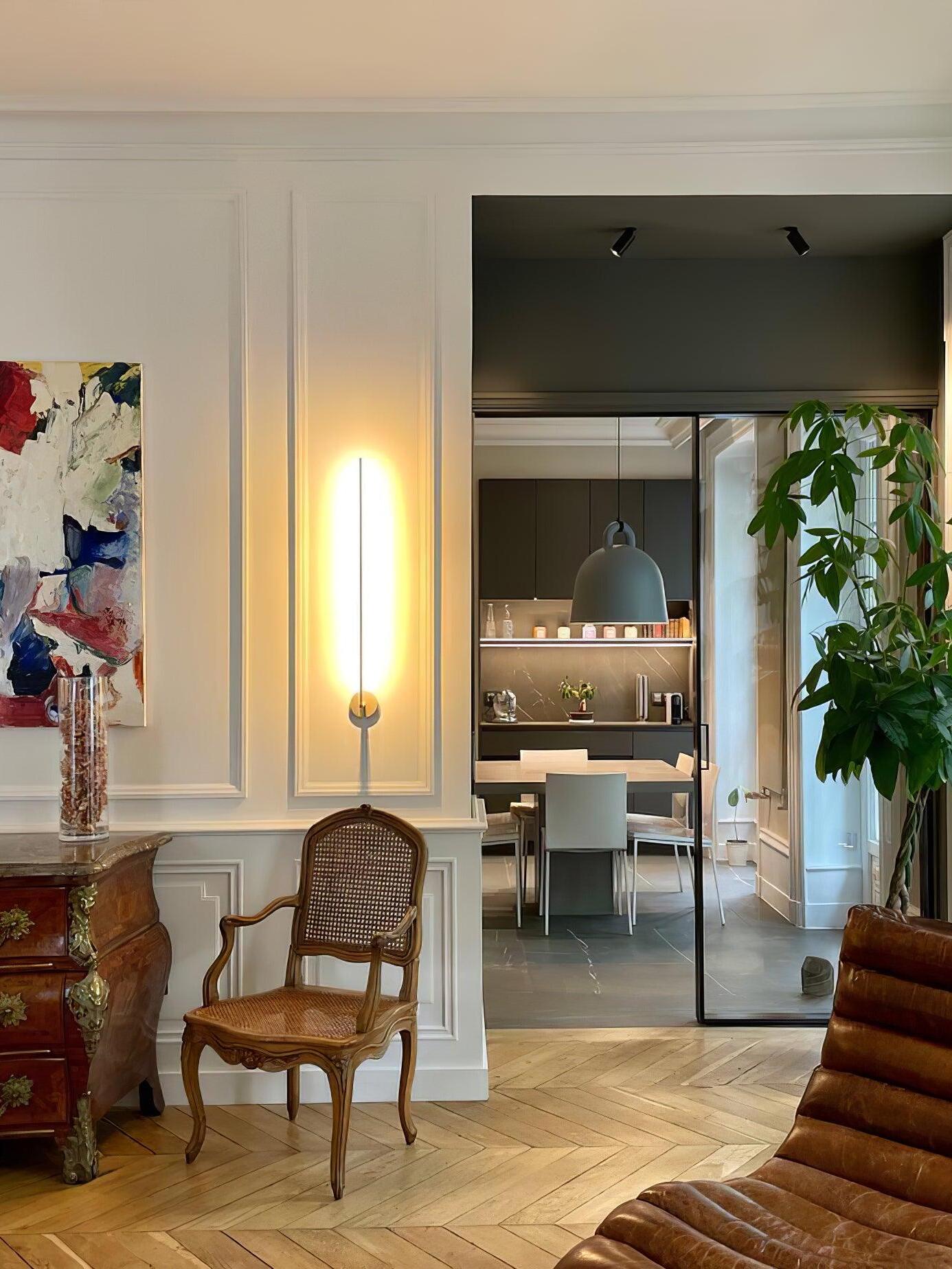 Bright linear wall light near an interior doorway