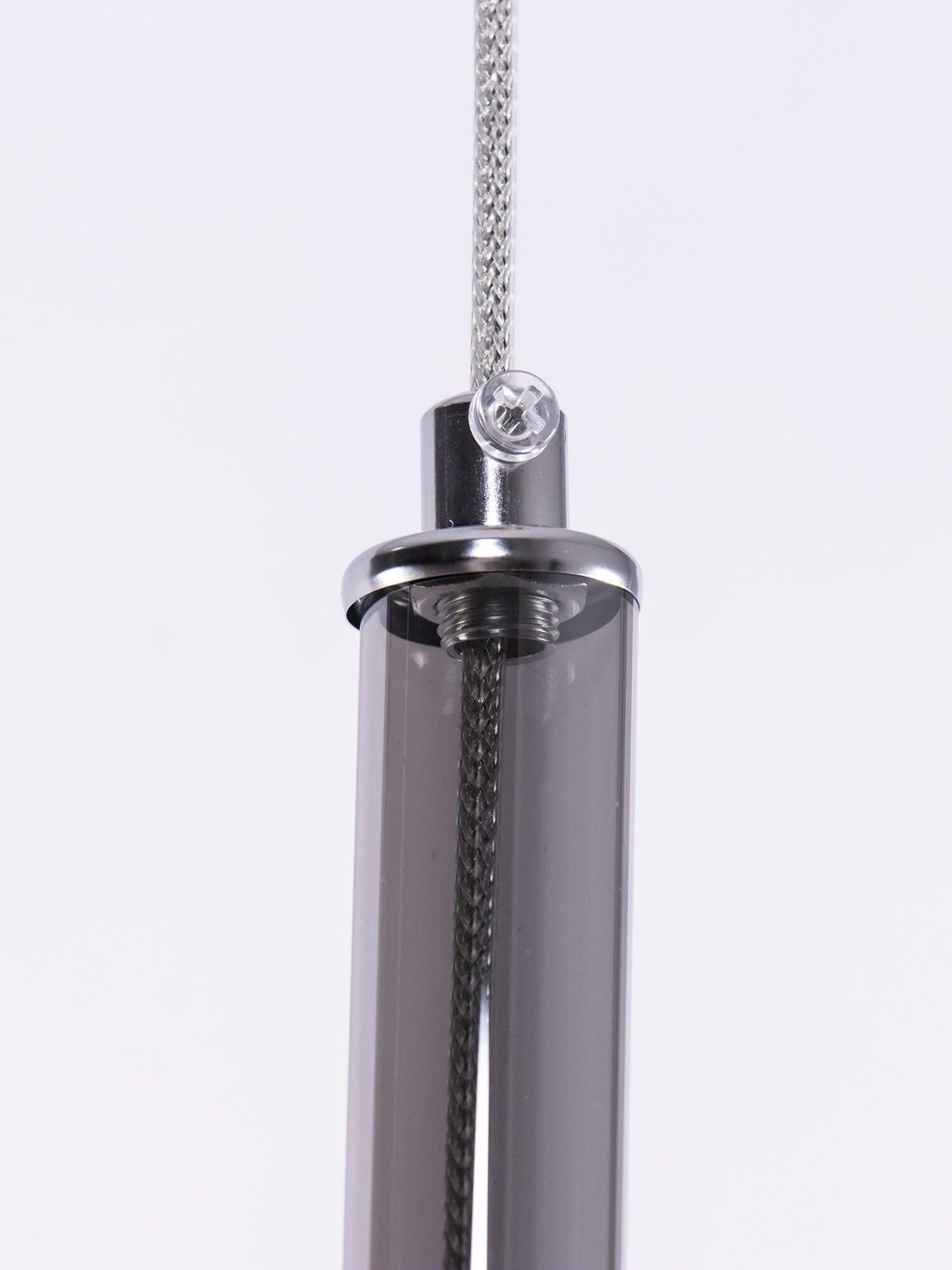 Close view of a dark translucent neck, metallic top cap, screw and suspension cord