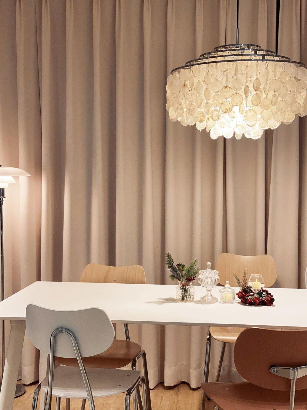 Round shell fixture above a cloth-covered table