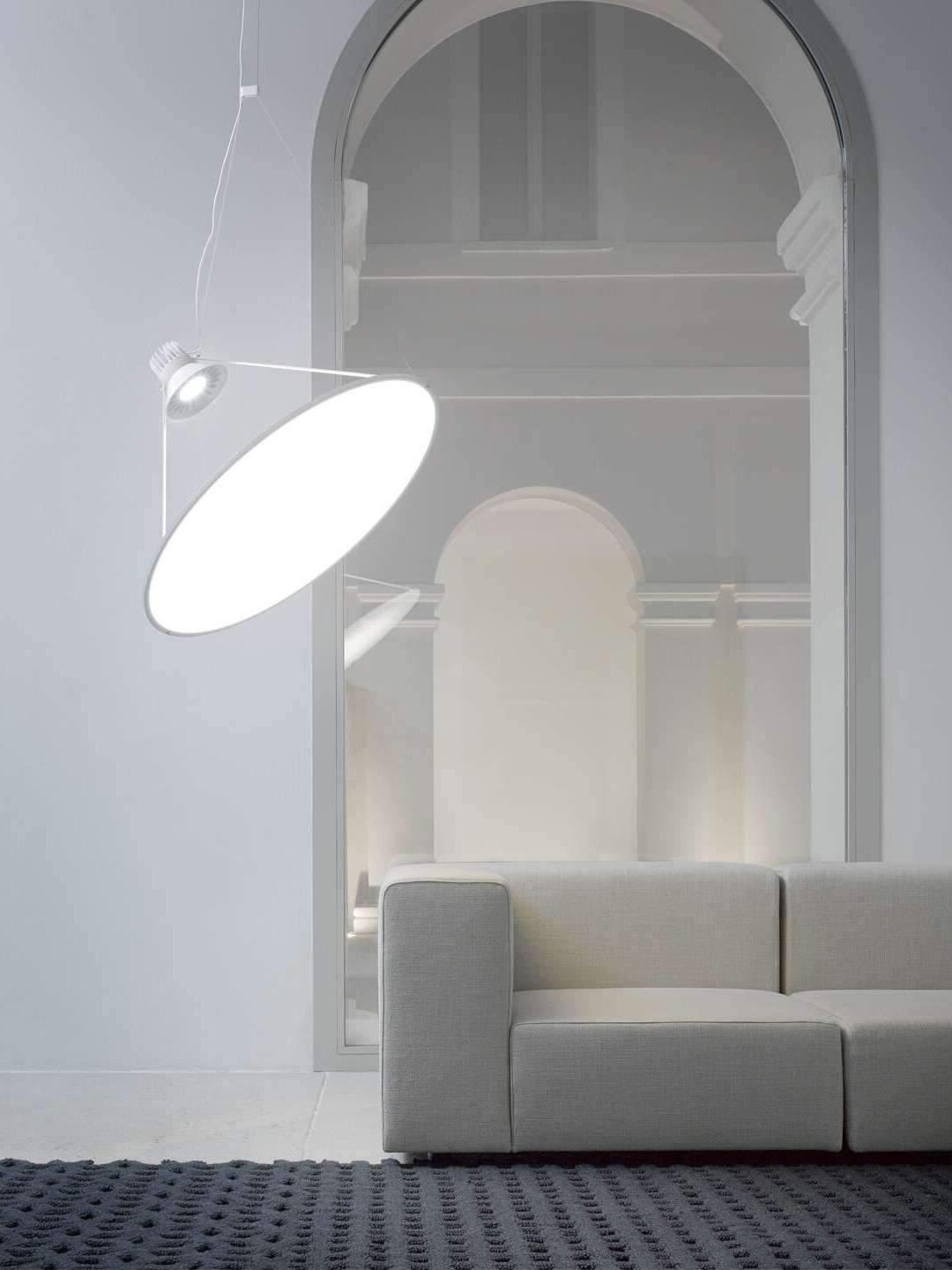 Pale suspended disc beside a seating area