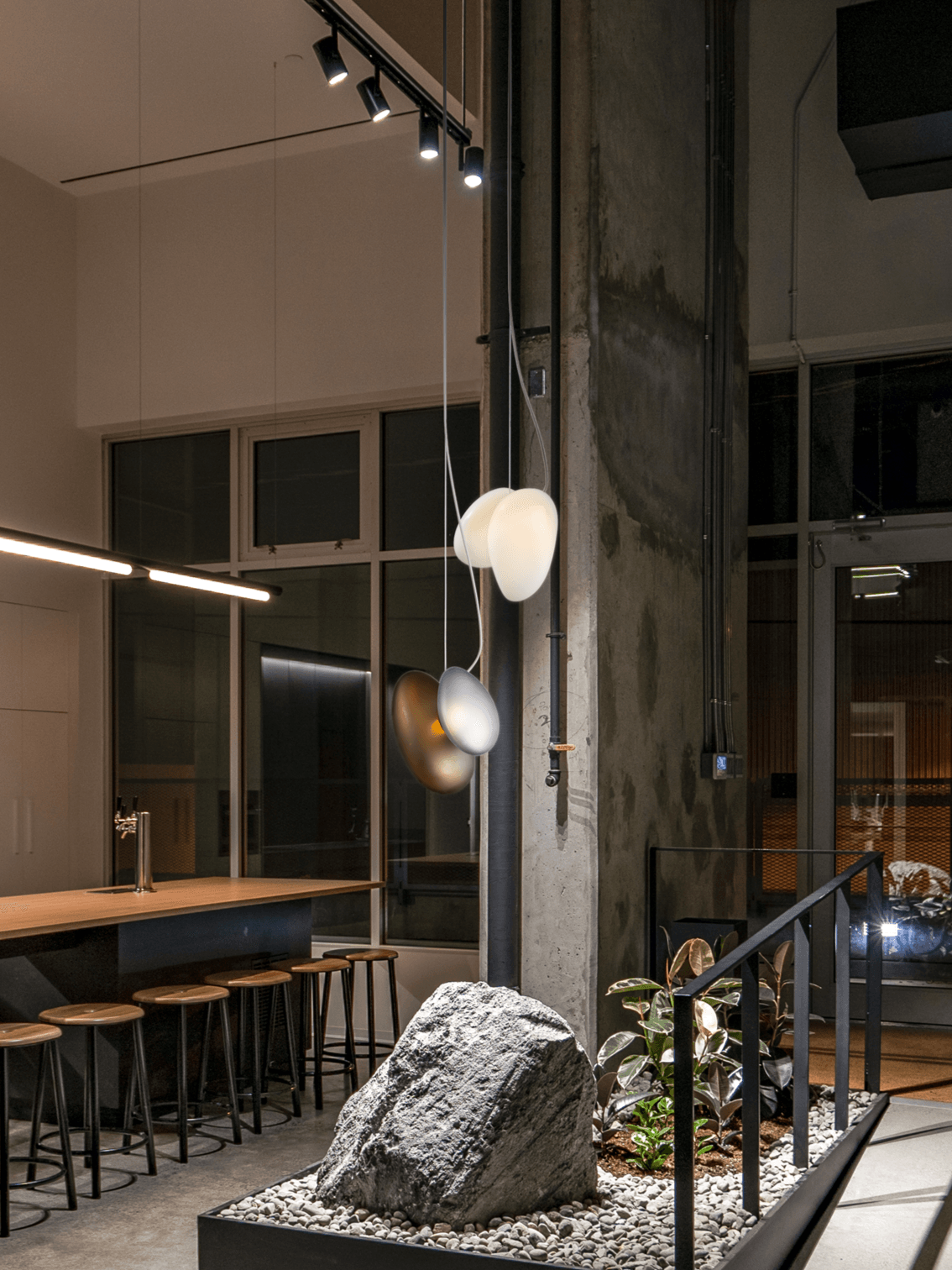 Two pebble pendants at different heights in an interior
