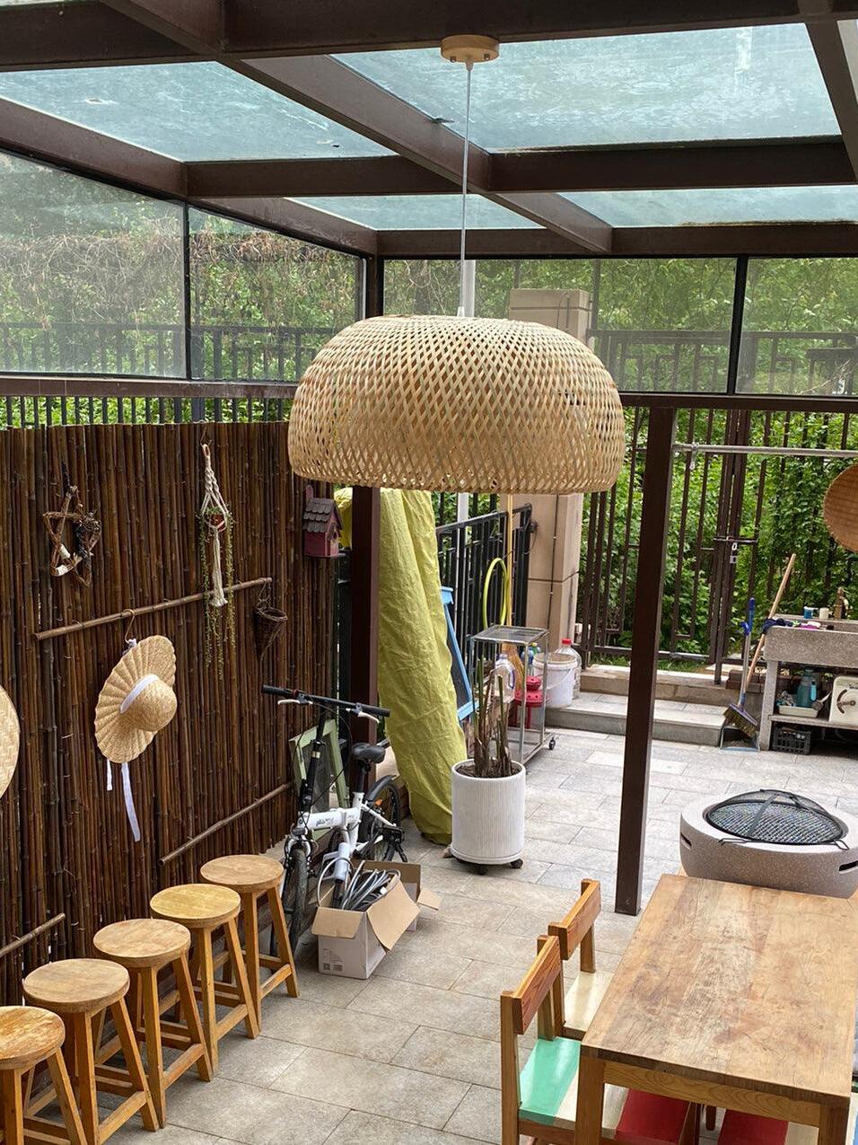 Closer view of bamboo pendant above covered terrace table