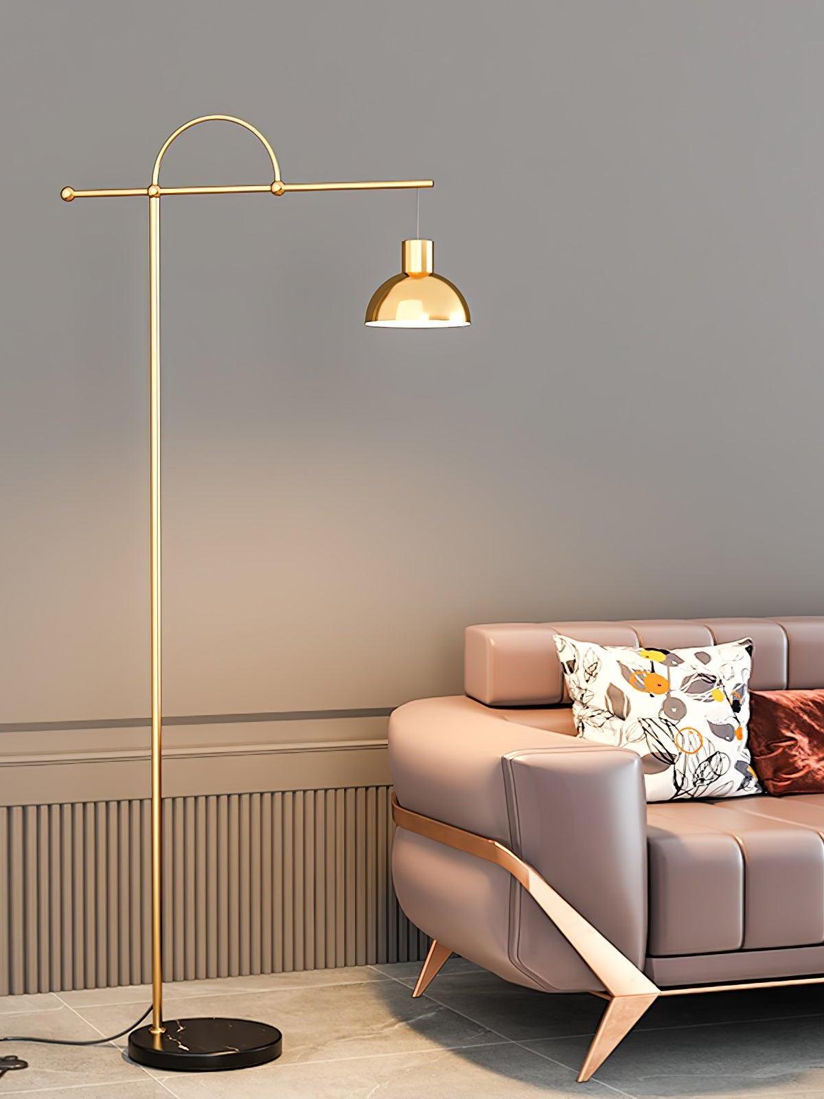 Nidal gold-colour offset bell shade over a seating area