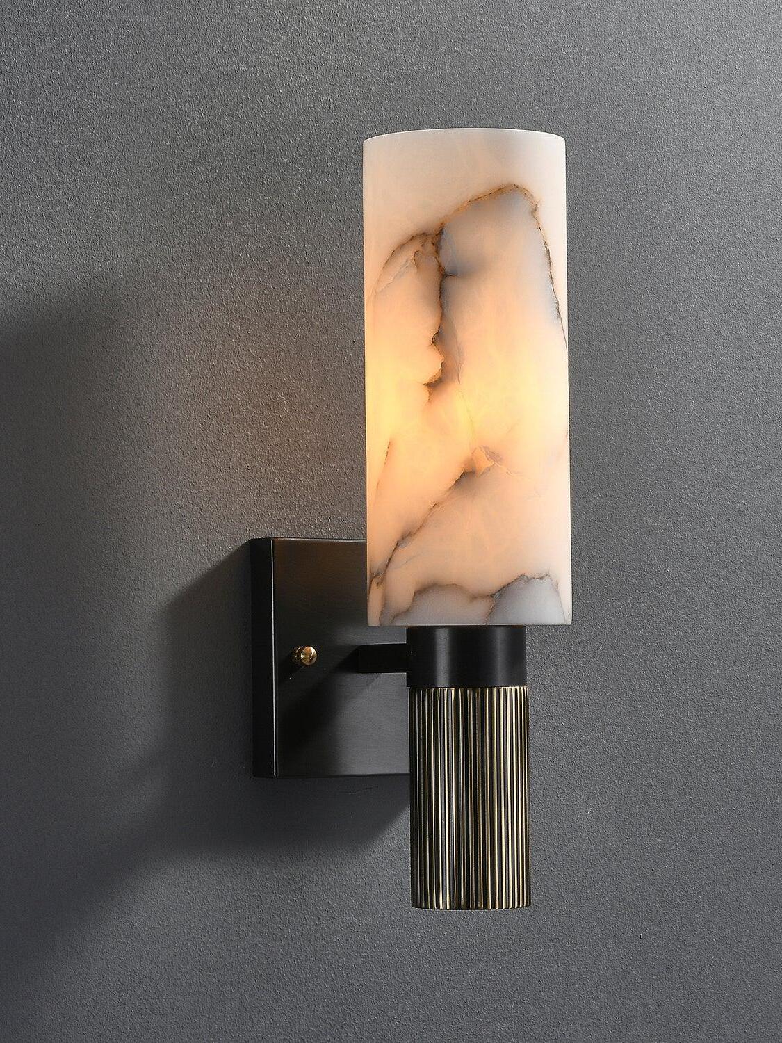 Lit marble cylinder above ribbed metal stem