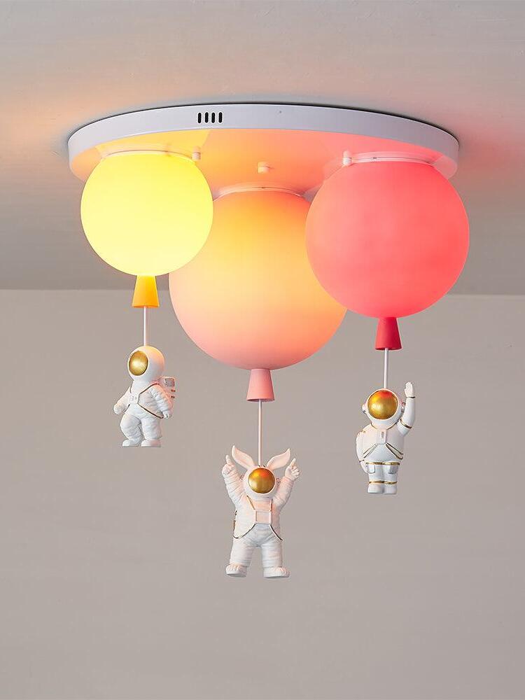 Pink red and orange balloon arrangement illuminated