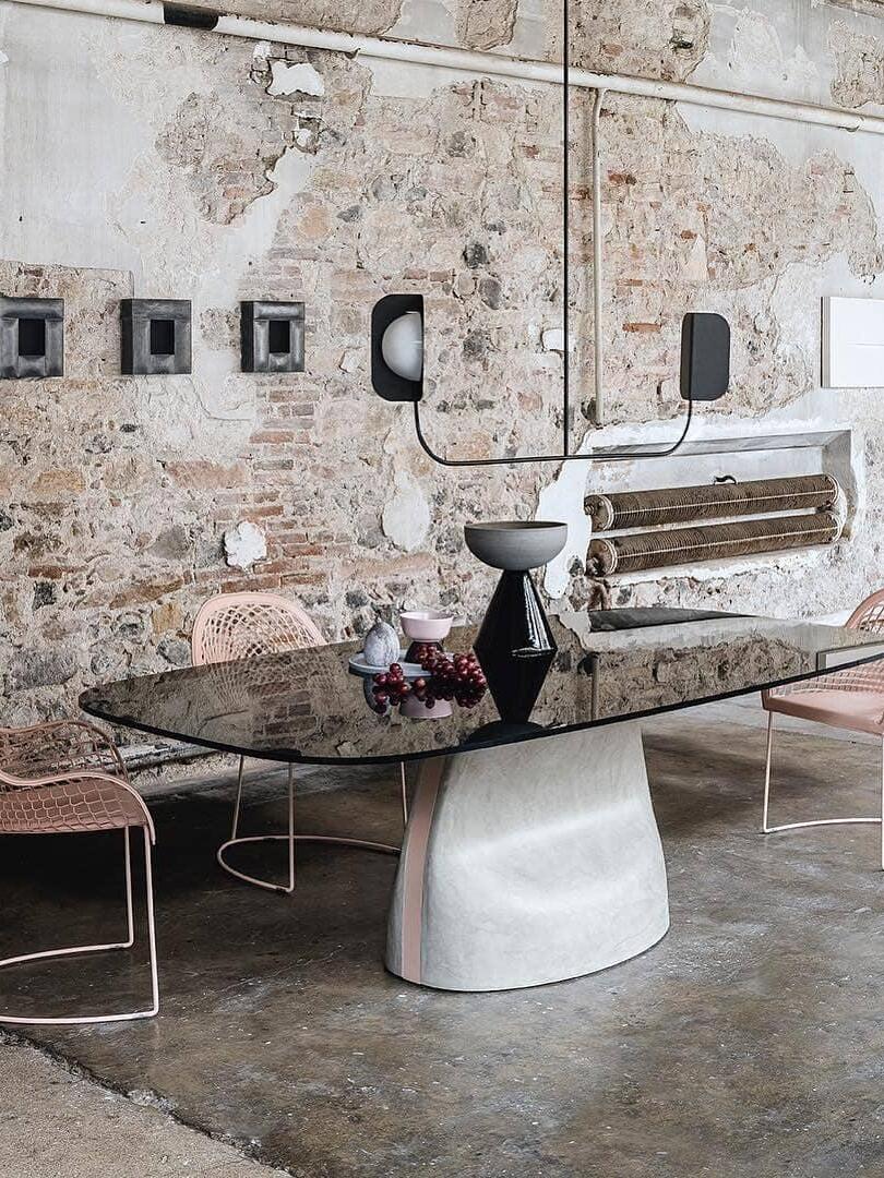 Black leaf-shield chandelier over a long console