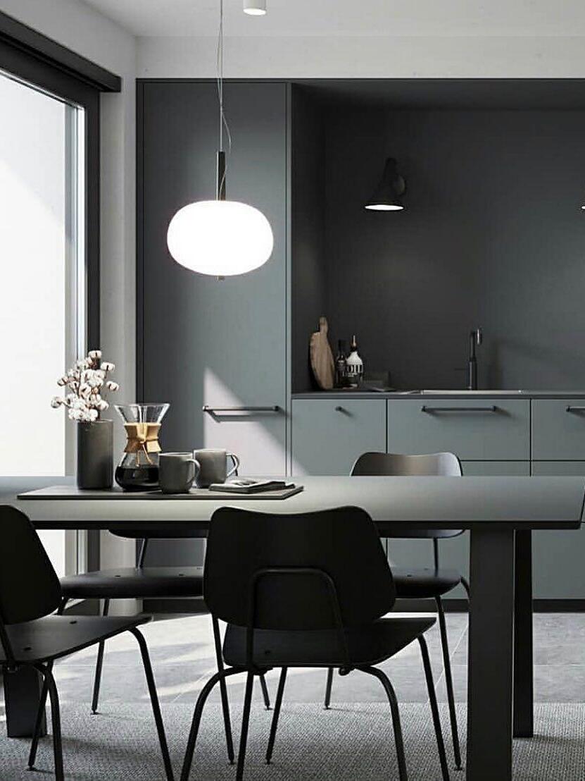 White globe pendant over a dark dining table