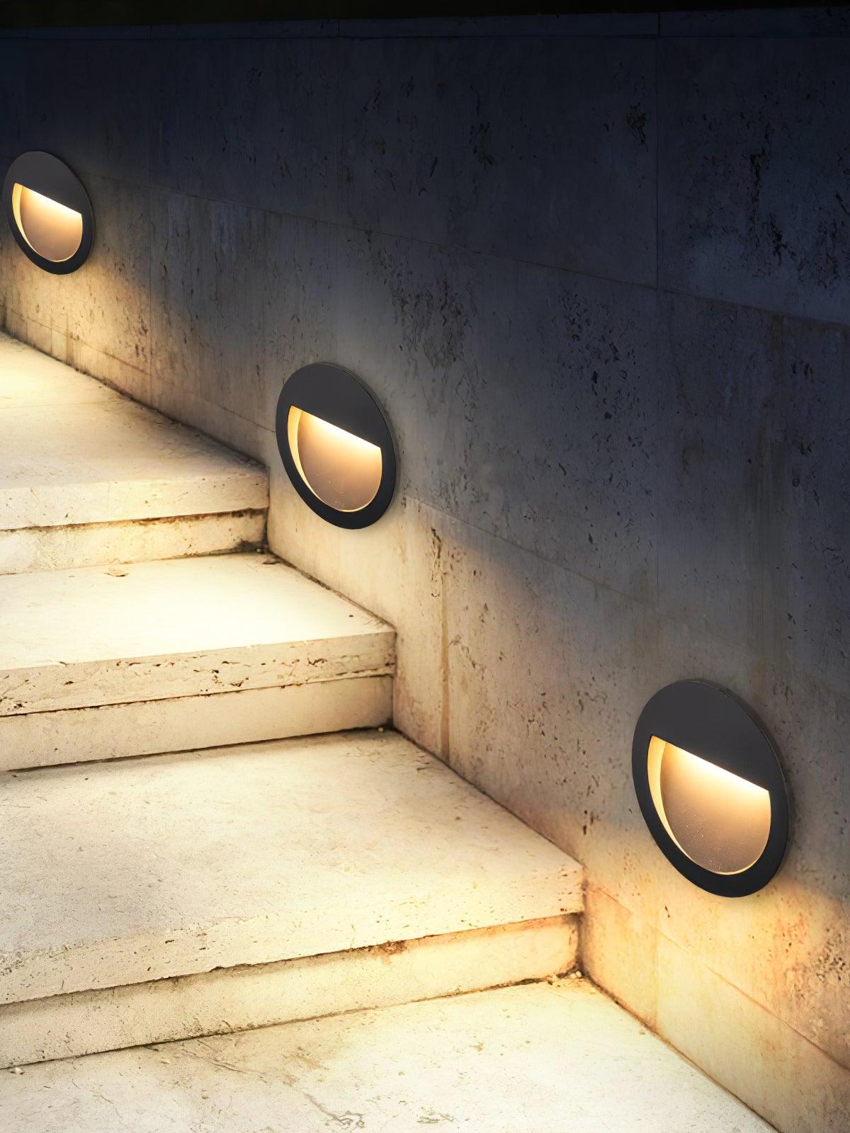 Three round lights beside outdoor stairs