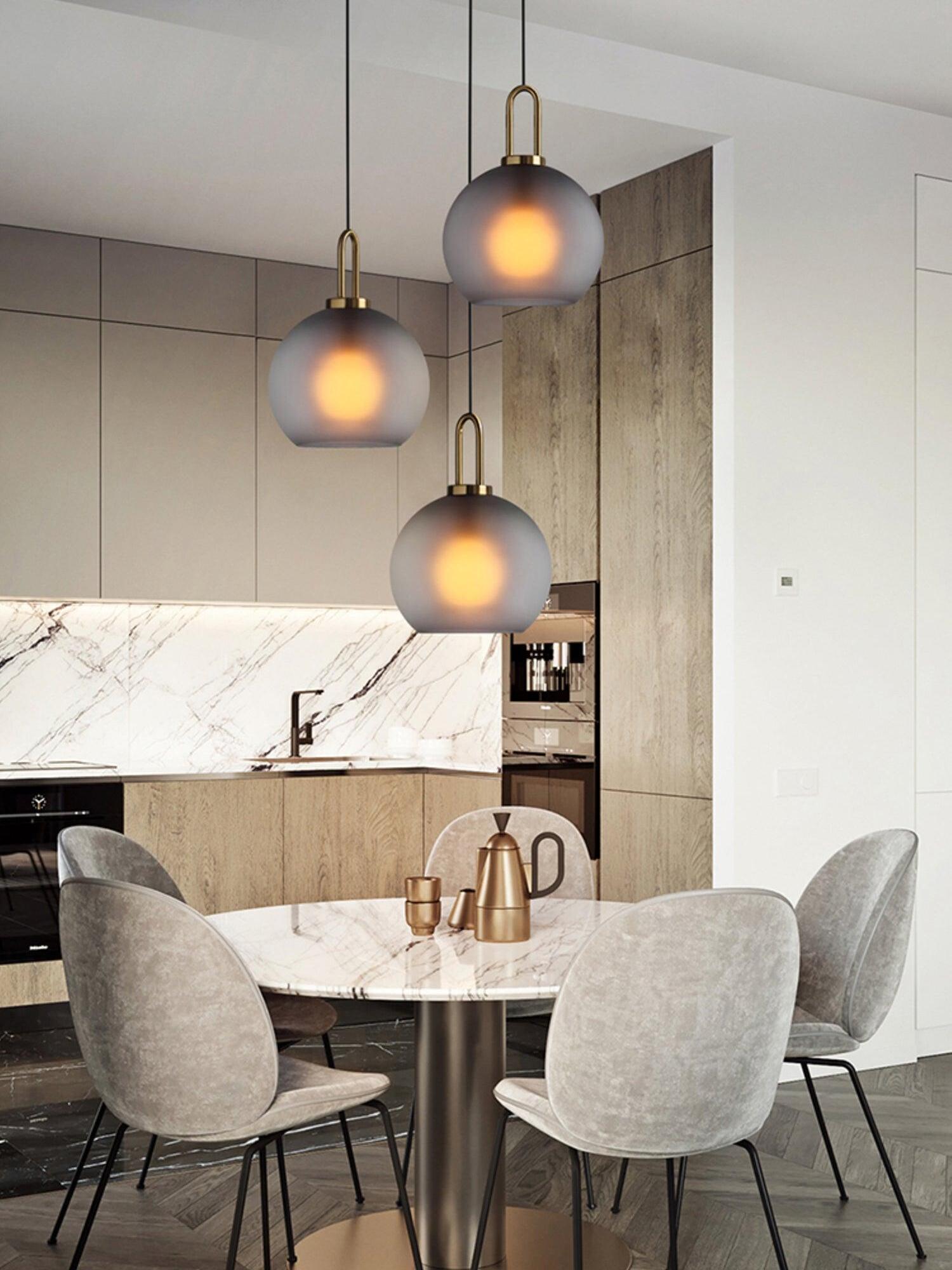 Three frosted globe pendants above a dining area