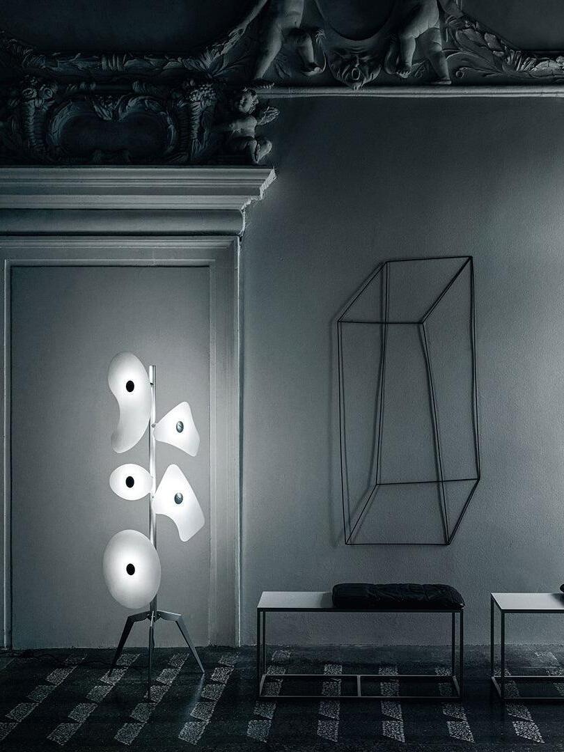 Illuminated white panel lamp near a dark fireplace