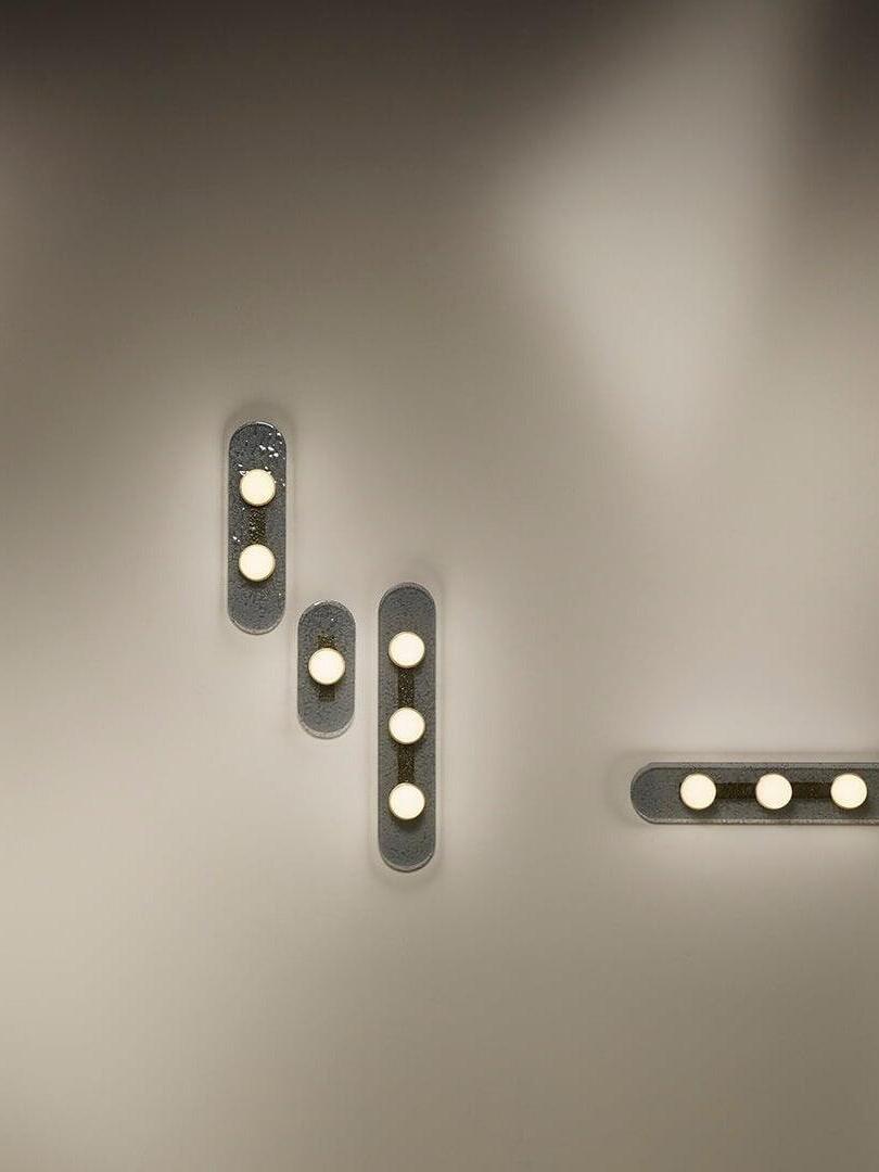 Different Modulo light arrangements on a wall, including a horizontal glass panel at the right