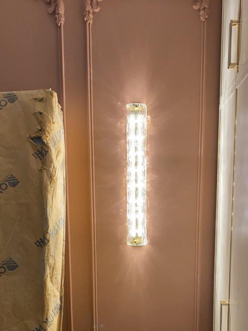 Glass wall light on ornamental pink wall