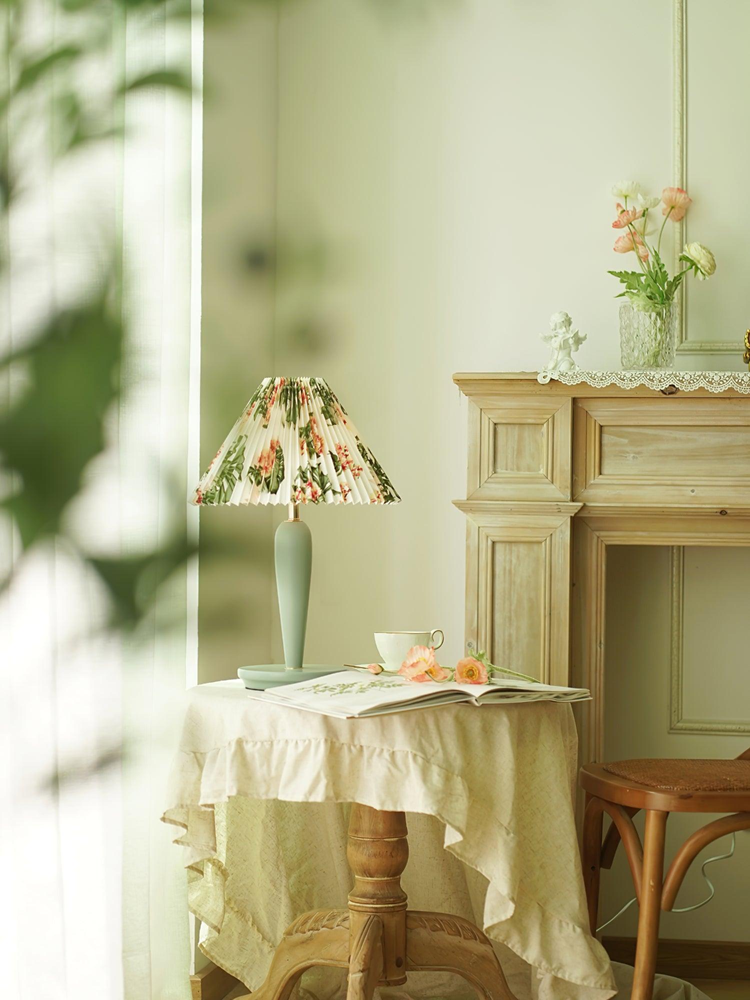 Light-blue floral-shade lamp in room by fireplace