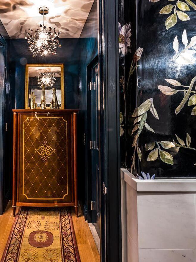 Small gold disc chandelier over a narrow hallway console