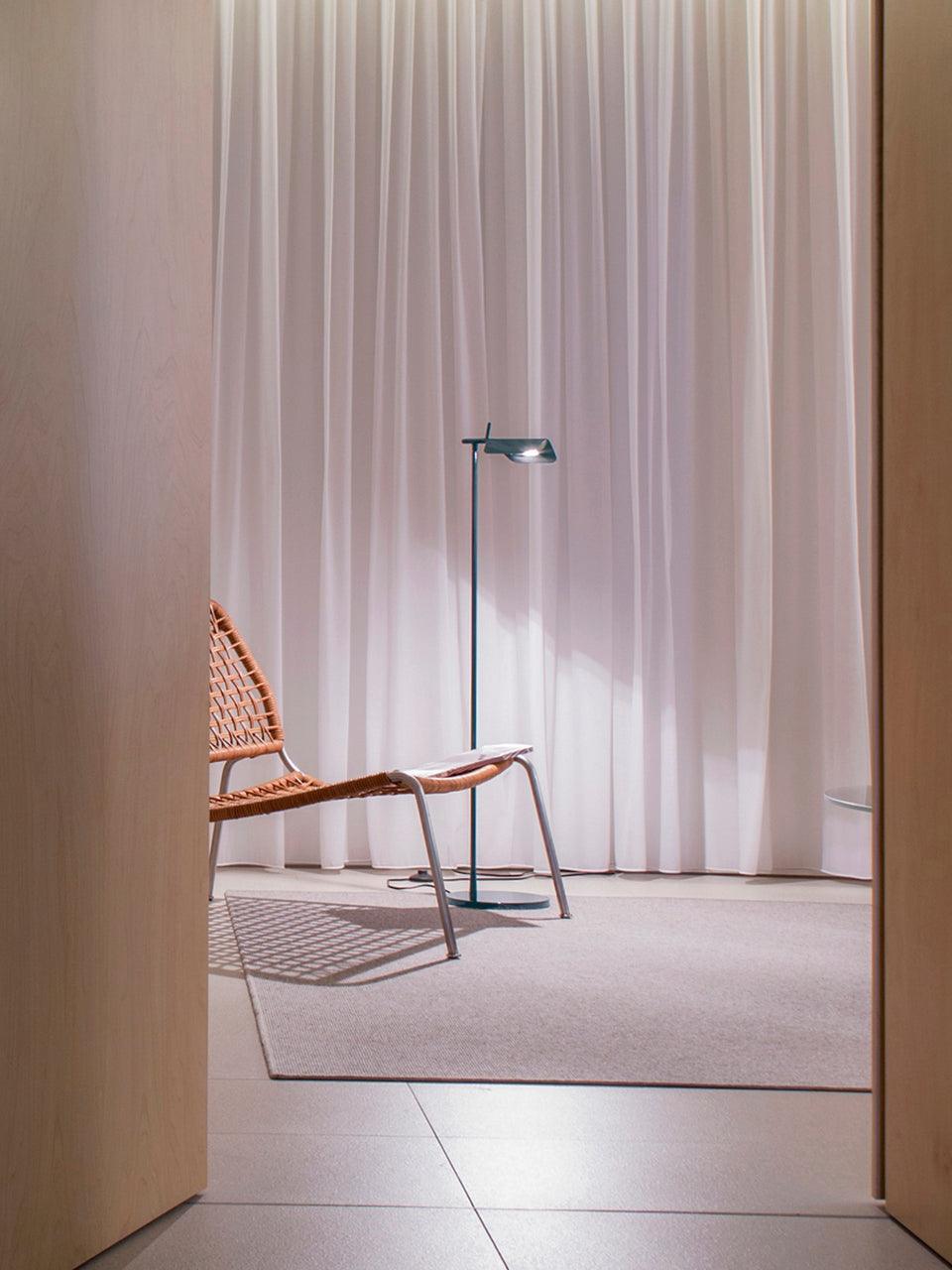 Blue-grey floor lamp beside a lounge chair