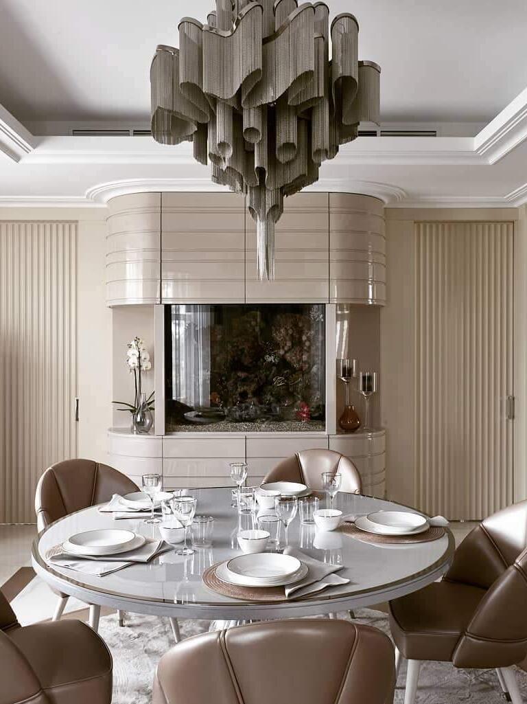 Dark-looking tiered chain chandelier above a dining table