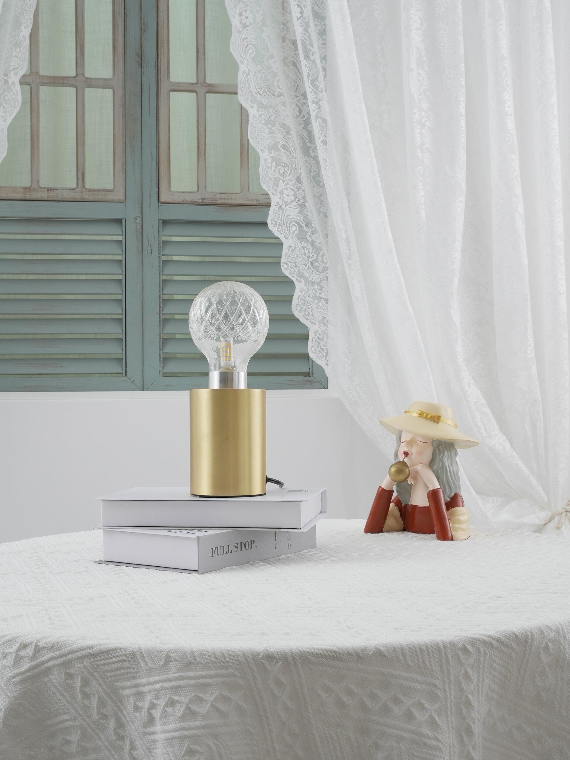 Clear globe lamp near green shutters and white curtain