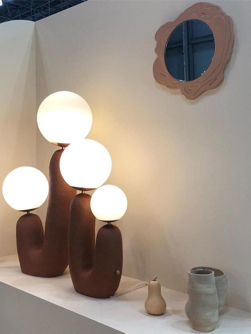 Brown-toned double-globe lamps displayed together