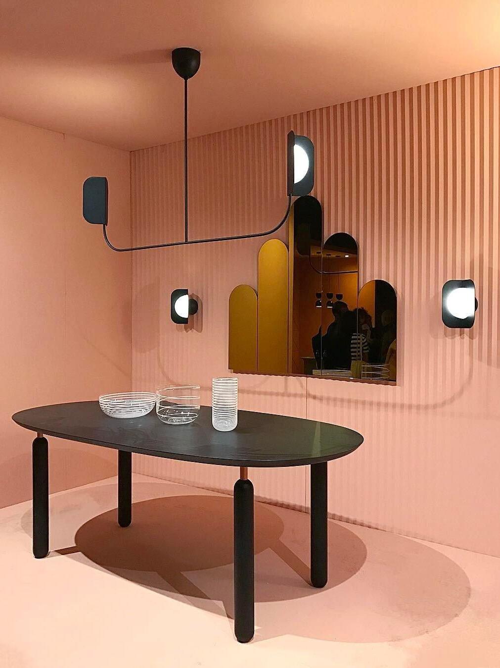 Black and gold-coloured leaf-like lights in a pink room