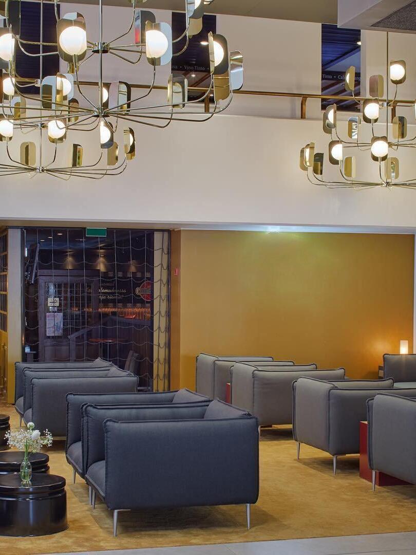 Gold-coloured chandeliers above a seating area