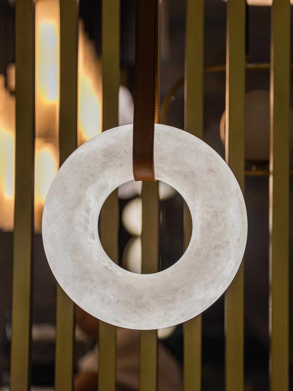 Upright alabaster ring against a slatted background