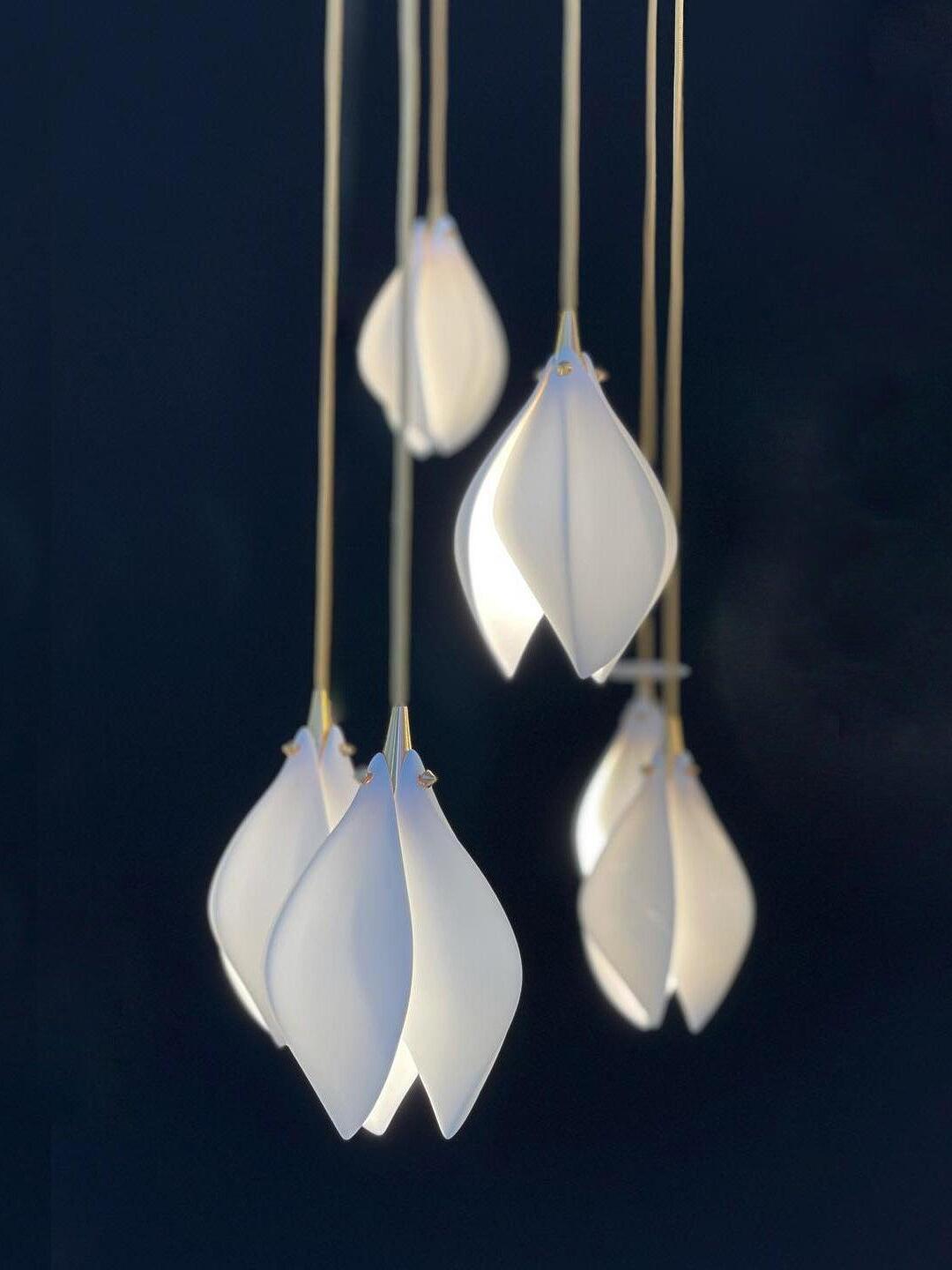 Five white petal-shaped lights visible in a cropped hanging arrangement