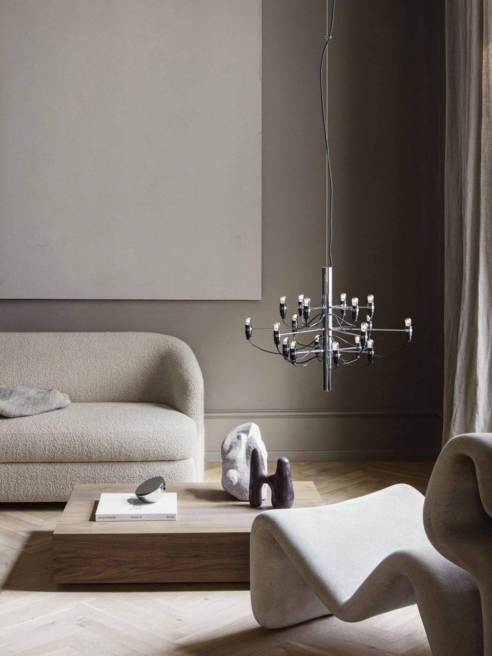 Small exposed-bulb chandelier in a neutral lounge